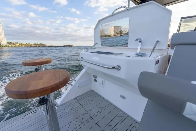 Slide: The Image of Luxury Hanover 387 boat interior with modern seating and ocean view, 2025 model. - 13