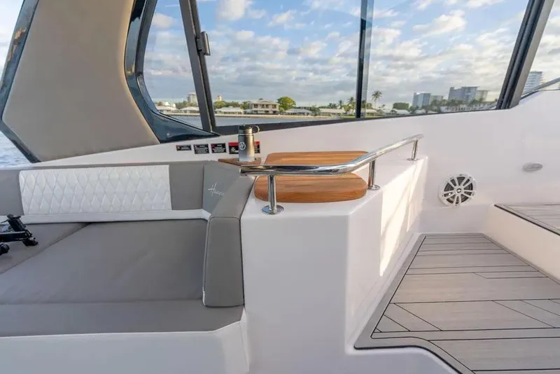 Slide: The Image of Luxurious interior of 2025 Hanover 387 yacht with elegant seating and scenic window view. - 22