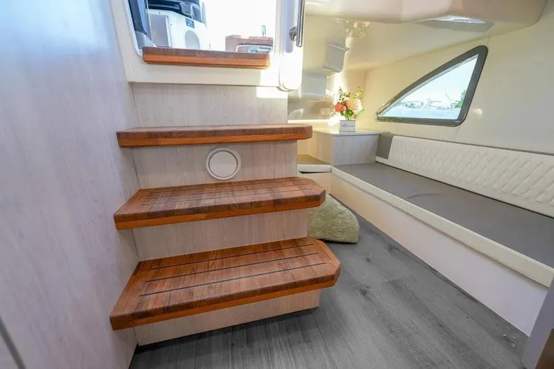 Slide: The Image of Luxurious interior of 2025 Hanover 387 yacht with wooden steps and elegant seating. - 23