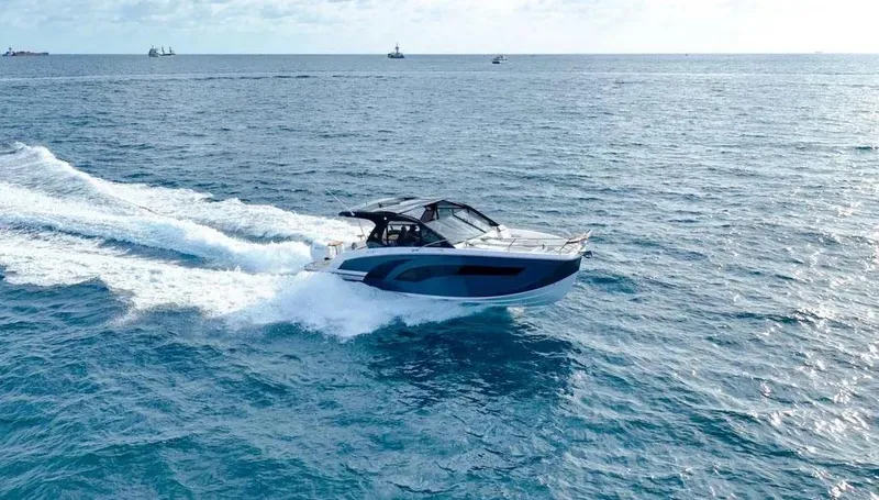 Slide: The Image of 2025 Hanover 387 boat cruising on open sea with clear skies. - 6