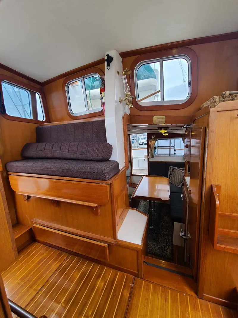 Slide: The Image of Interior of 1989 Eagle 32 Trawler with wooden finish and seating area. - 11