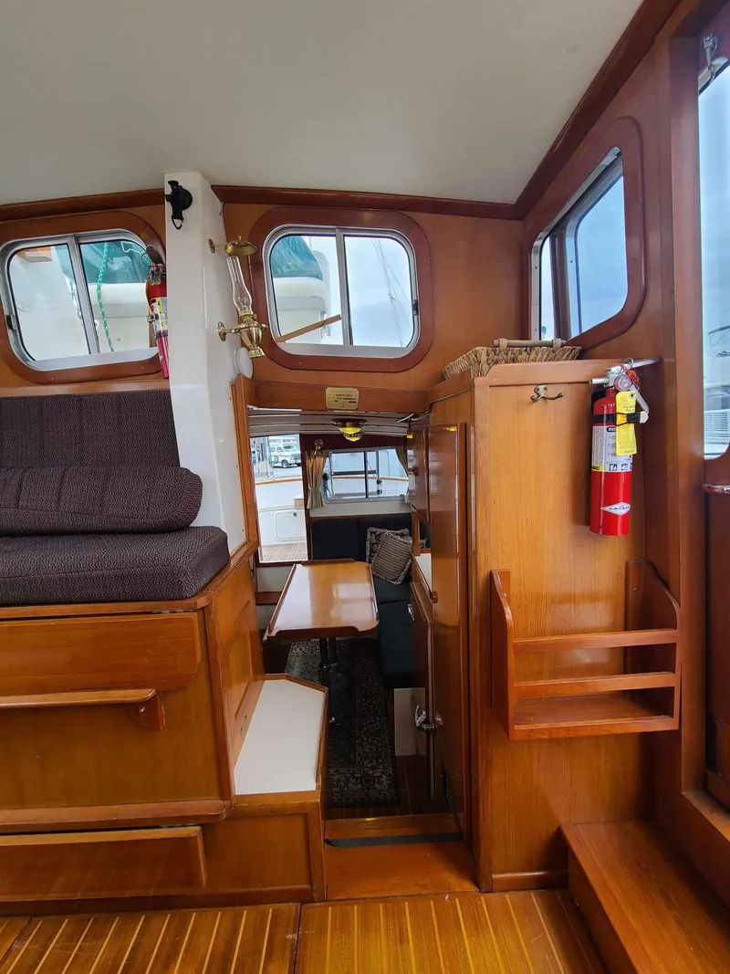 Slide: The Image of Interior of 1989 Eagle 32 Trawler with wooden finishes and seating area. - 12