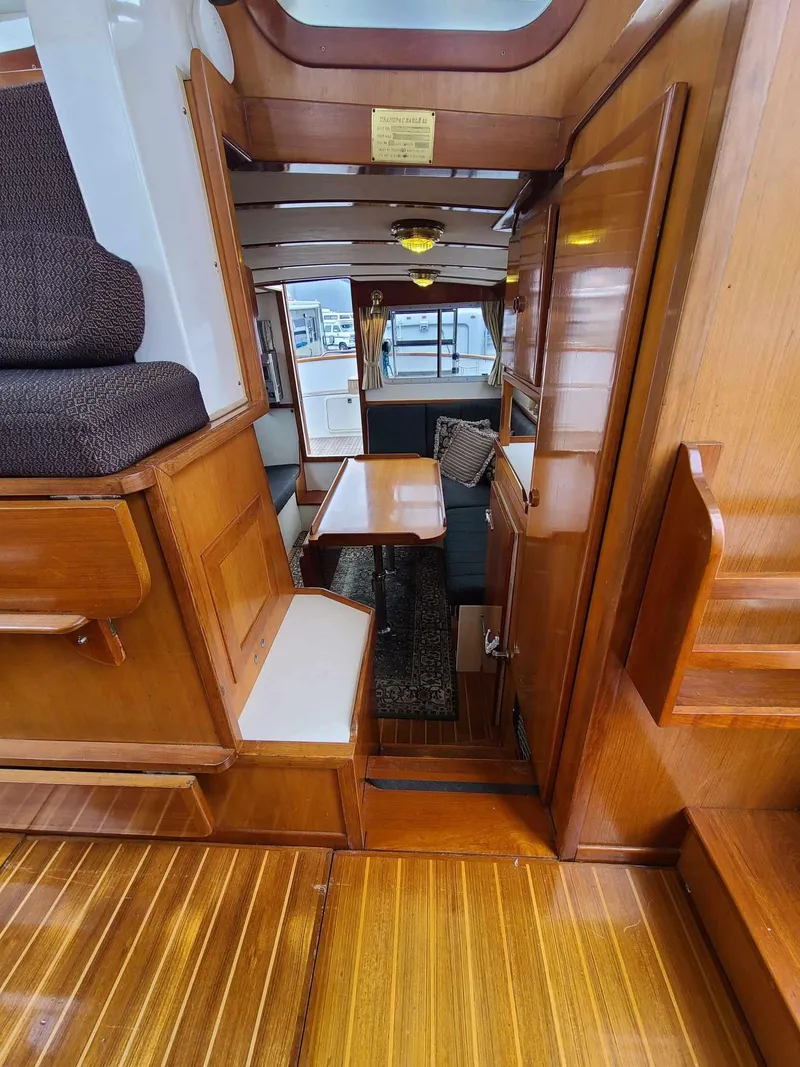 Slide: The Image of Interior of 1989 Eagle 32 Trawler with wooden finishes and seating area. - 13