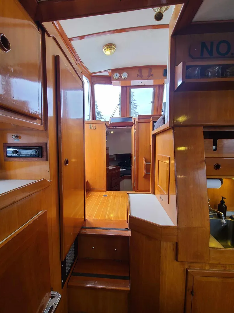 Slide: The Image of Interior of 1989 Eagle 32 Trawler with wooden cabinetry and compact layout. - 18