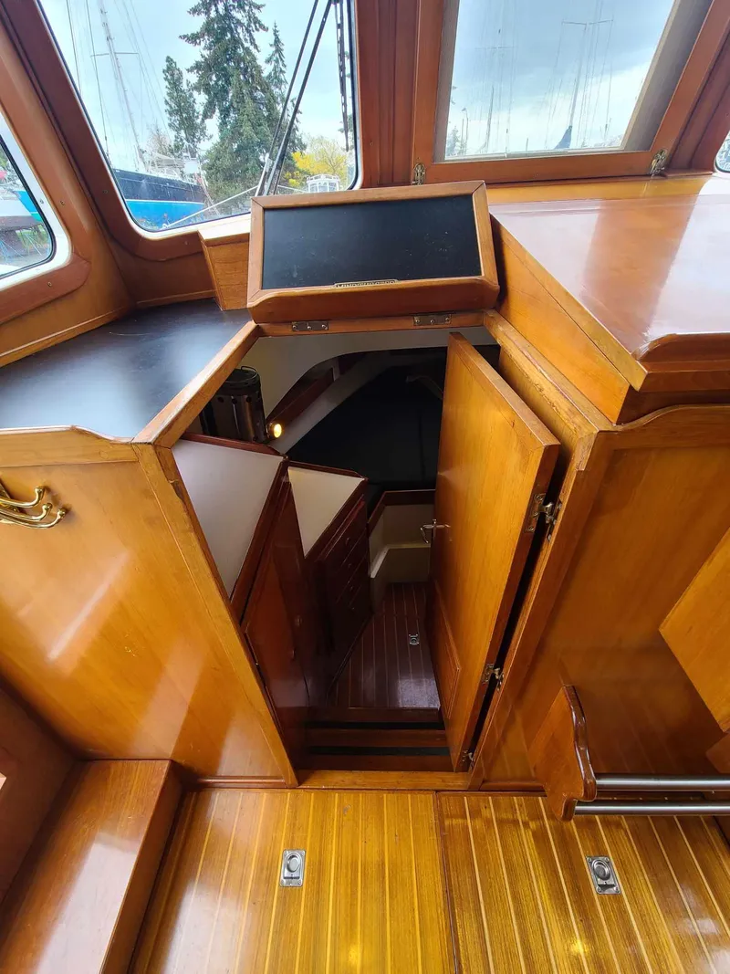 Slide: The Image of Interior view of 1989 Eagle 32 Trawler with wooden cabinetry and stairs. - 19