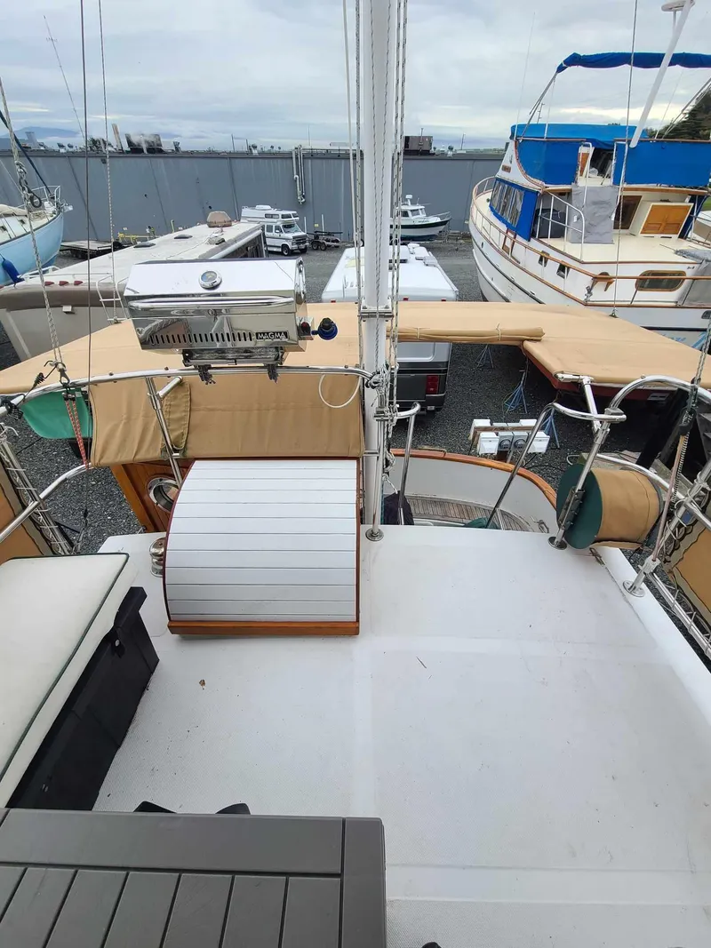 Slide: The Image of 1989 Eagle 32 Trawler deck view with seating and equipment, docked among other boats. - 2