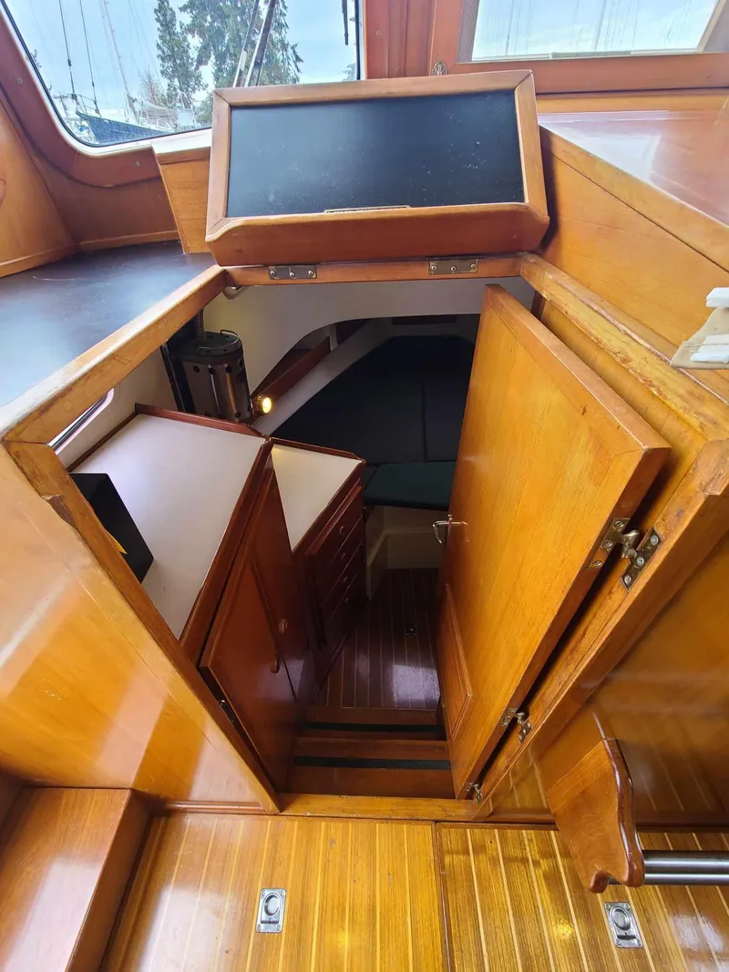 Slide: The Image of Interior view of 1989 Eagle 32 Trawler, showcasing wooden cabin and stairs. - 20