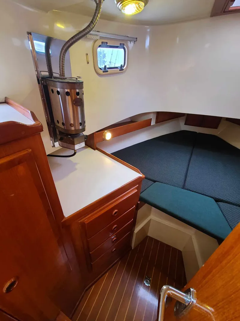 Slide: The Image of Cozy cabin interior of 1989 Eagle 32 Trawler with wood finish and compact heater. - 22