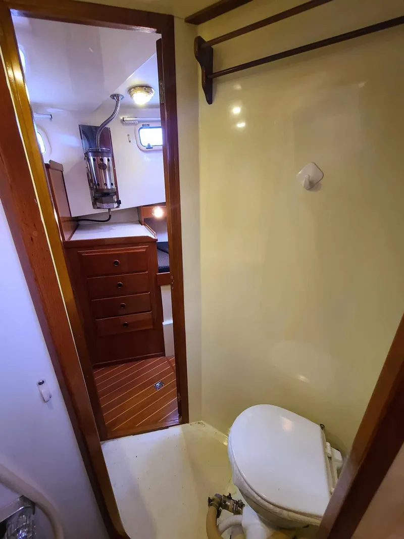 Slide: The Image of 1989 Eagle 32 Trawler bathroom with toilet and wooden cabinetry. - 26