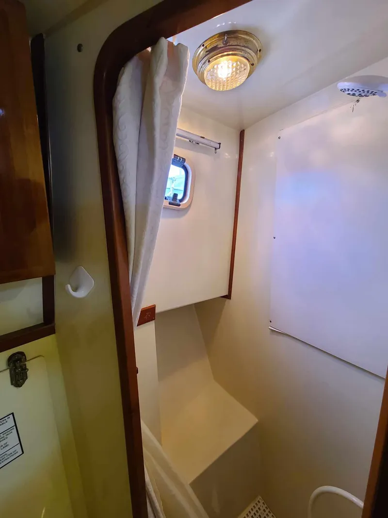 Slide: The Image of Compact bathroom in 1989 Eagle 32 Trawler with shower and porthole window. - 27