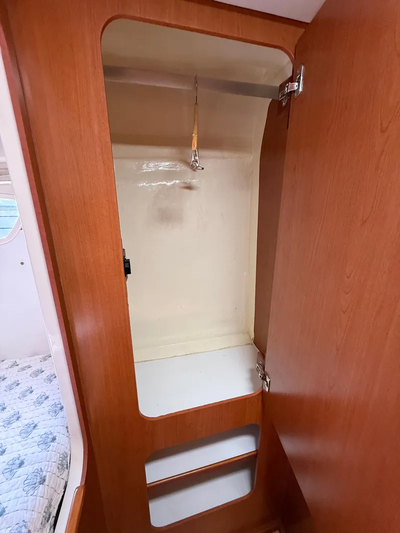 Slide: The Image of Empty wooden closet inside a 2010 Leopard 38 boat cabin. - 10