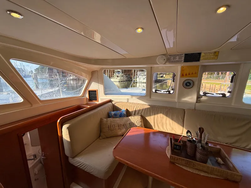 Slide: The Image of Cozy interior of a 2010 Leopard 38 catamaran with dining area and large windows. - 15