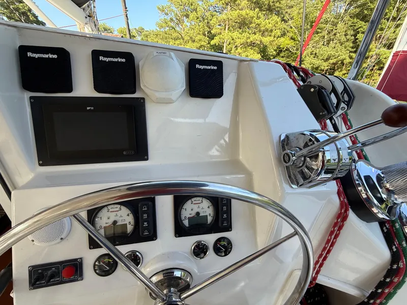 Slide: The Image of Helm of 2010 Leopard 38 catamaran with Raymarine navigation equipment and steering wheel. - 16