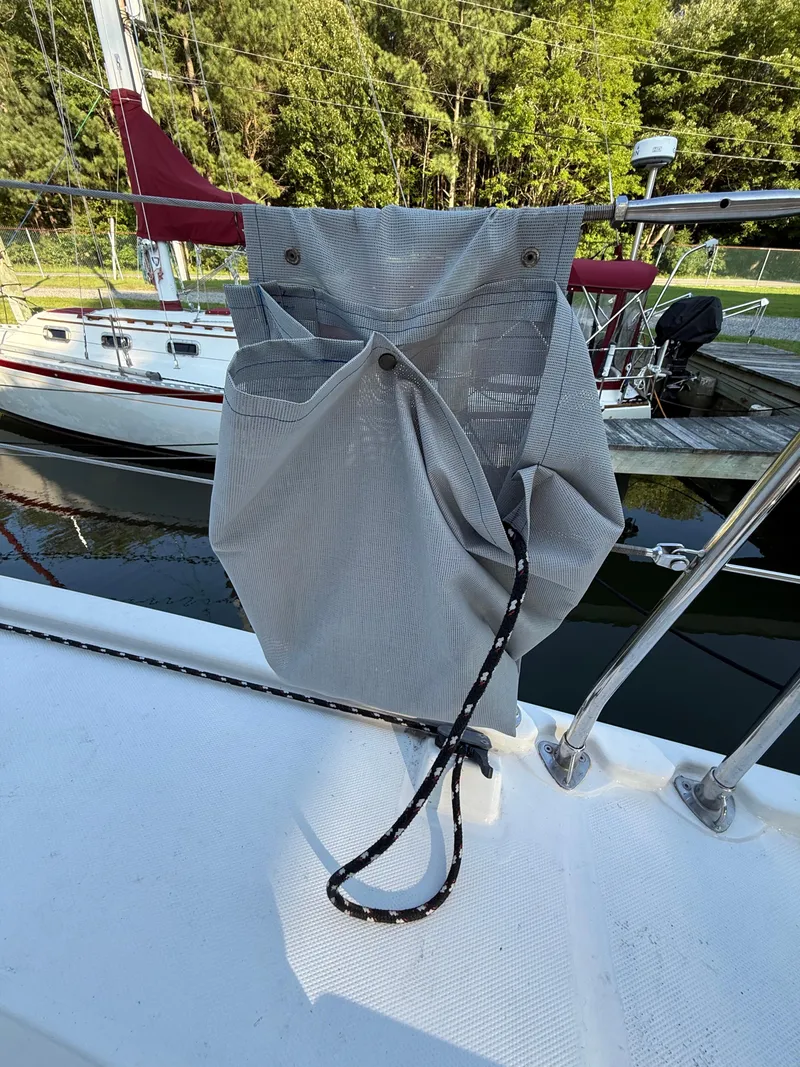 Slide: The Image of Gray storage bag on a 2010 Leopard 38 sailboat deck, with docked boats in background. - 19