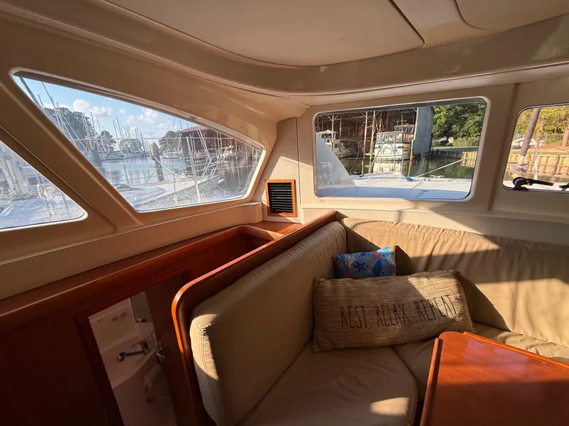 Slide: The Image of Interior of 2010 Leopard 38 yacht with cozy seating and marina view. - 8