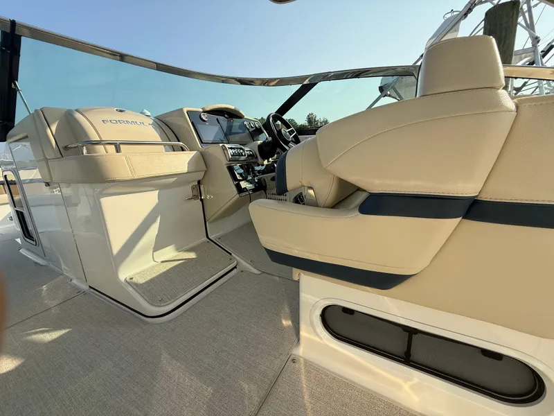 Slide: The Image of 2024 Formula 350 Crossover Bowrider interior with beige seating and modern dashboard. - 13
