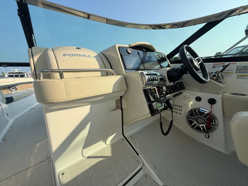 Slide: The Image of 2024 Formula 350 Crossover Bowrider helm with modern controls and luxurious seating. - 16