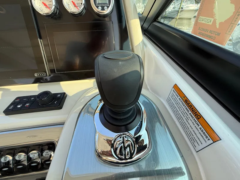 Slide: The Image of 2024 Formula 350 Crossover Bowrider dashboard with controls and warning label. - 17