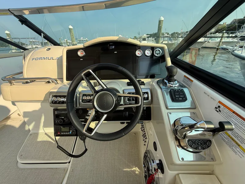 Slide: The Image of 2024 Formula 350 Crossover Bowrider helm with modern controls and steering wheel. - 19