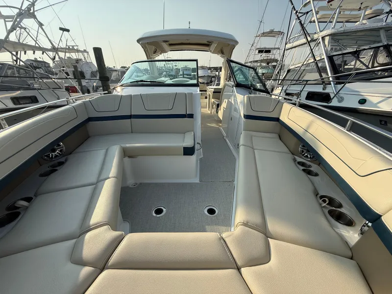 Slide: The Image of 2024 Formula 350 Crossover Bowrider with spacious seating and modern design in a marina setting. - 21