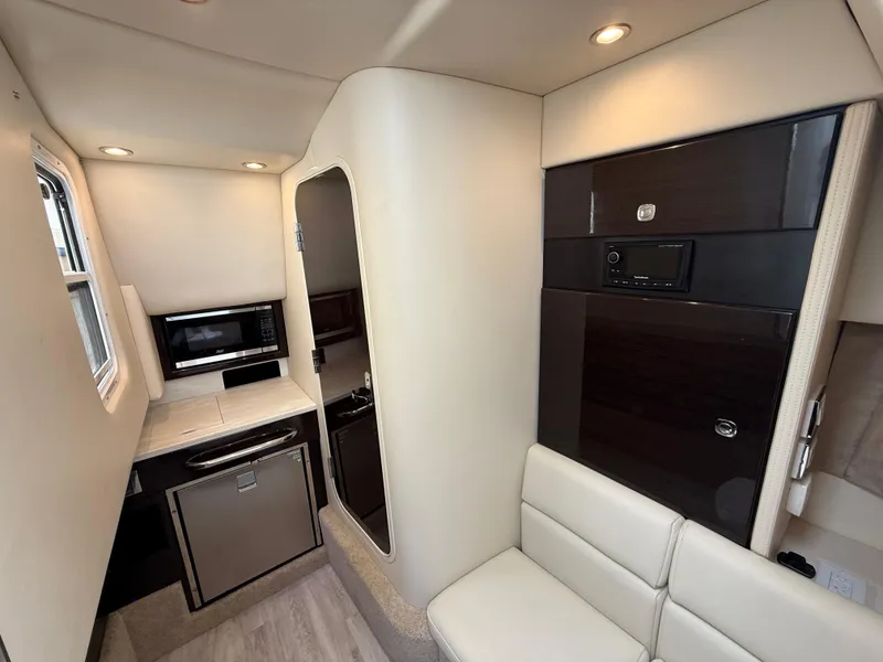 Slide: The Image of 2024 Formula 350 Crossover Bowrider interior with kitchenette and seating area. - 29