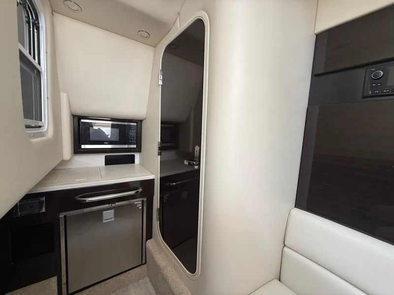 Slide: The Image of 2024 Formula 350 Crossover Bowrider interior with microwave and mini-fridge. - 30