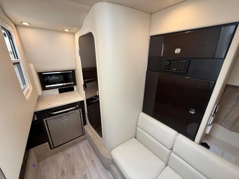 Slide: The Image of 2024 Formula 350 Crossover Bowrider interior with kitchenette and seating area. - 31