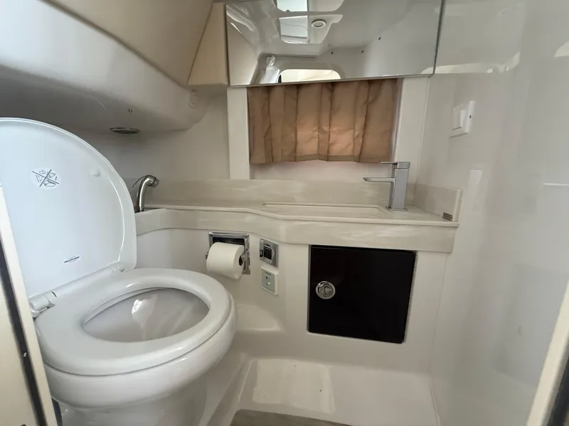 Slide: The Image of 2024 Formula 350 Crossover Bowrider bathroom with toilet, sink, and mirror. - 34