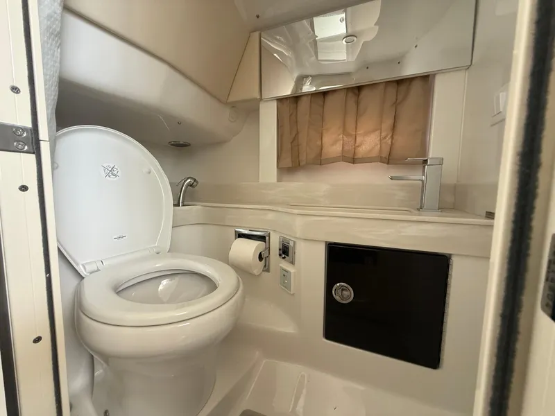 Slide: The Image of 2024 Formula 350 Crossover Bowrider bathroom with toilet, sink, and storage. - 35