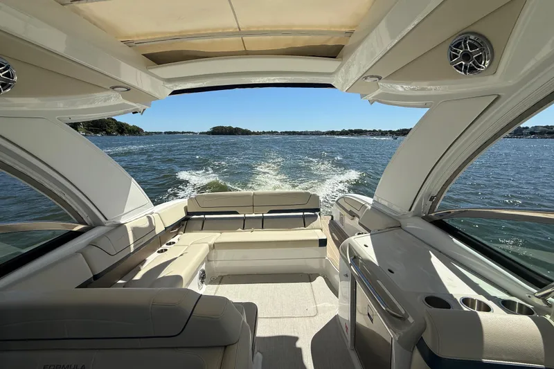 Slide: The Image of 2024 Formula 350 Crossover Bowrider cruising on a sunny lake, showcasing luxurious interior. - 4