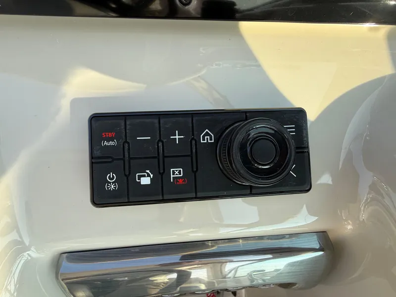 Slide: The Image of Control panel of 2024 Formula 350 Crossover Bowrider boat with various buttons and dial. - 51