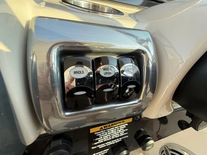 Slide: The Image of 2024 Formula 350 Crossover Bowrider dashboard controls with window and wiper switches. - 56