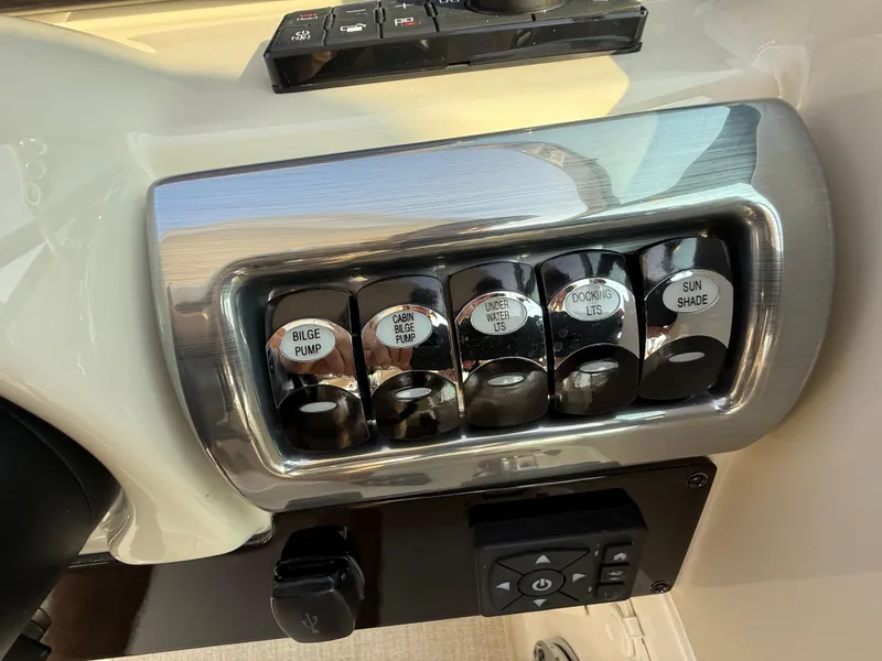 Slide: The Image of Control panel of 2024 Formula 350 Crossover Bowrider with labeled switches. - 58