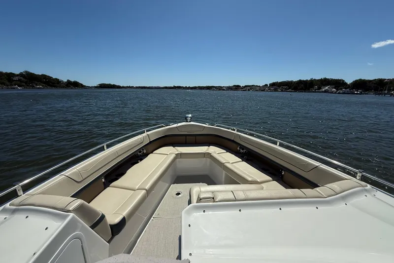 Slide: The Image of 2024 Formula 350 Crossover Bowrider on calm water, showcasing spacious seating and sleek design. - 66