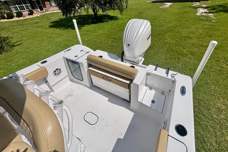 Slide: The Image of 2024 Sportsman Open 232 Center Console boat with Yamaha engine, viewed from above on grass. - 4