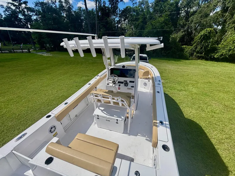 Slide: The Image of 2024 Sportsman Open 232 Center Console boat on grassy area, showcasing interior and helm. - 5