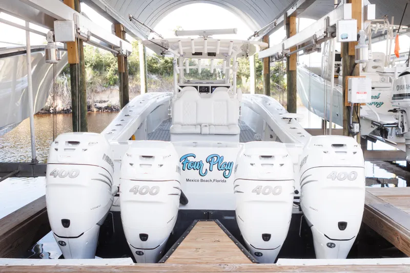 Slide: The Image of 2021 Tag 360 Catamaran with four powerful outboard engines docked in a covered marina. - 10