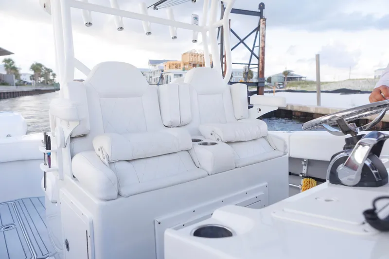 Slide: The Image of Luxurious seating on a 2021 Tag 360 Catamaran, featuring plush white upholstery and modern design. - 14