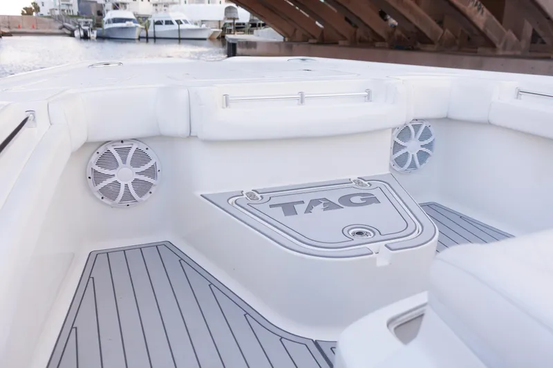 Slide: The Image of 2021 Tag 360 Catamaran interior with speakers and sleek design in a marina setting. - 15