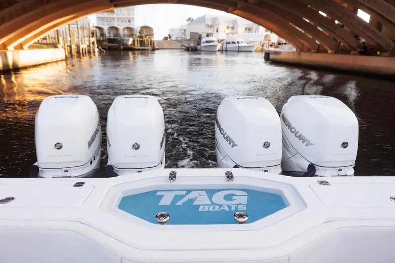 Slide: The Image of 2021 Tag 360 Catamaran with four Mercury outboard engines under a bridge. - 17