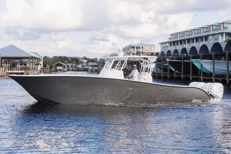 Slide: The Image of 2021 Tag 360 Catamaran cruising on water near docks and buildings. - 5