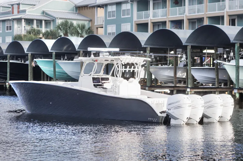 Slide: The Image of 2021 Tag 360 Catamaran with four engines docked near waterfront homes. - 7