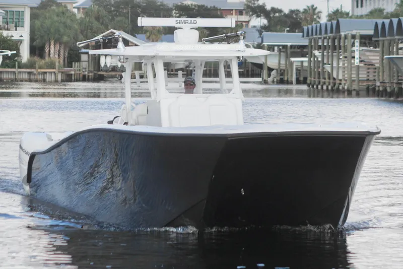 Slide: The Image of 2021 Tag 360 Catamaran cruising on a calm waterway, front view. - 8