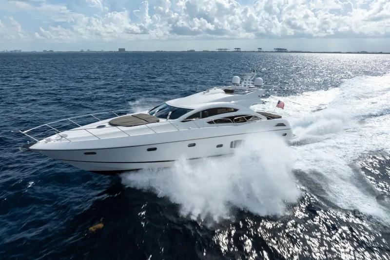 Slide: The Image of Sunseeker 74 Sport Yacht 2012 cruising on open sea under a cloudy sky. - 0