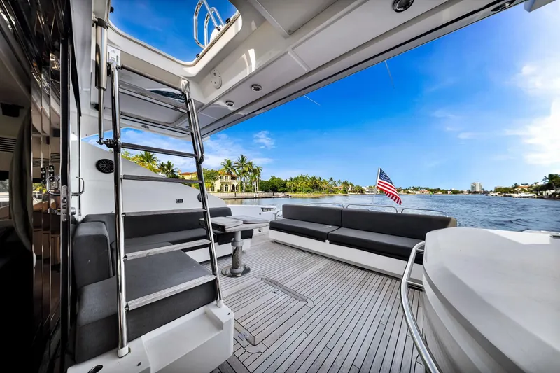 Slide: The Image of Luxurious 2012 Sunseeker 74 Sport Yacht deck with seating, ladder, and scenic waterfront view. - 10