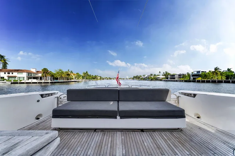 Slide: The Image of Sunseeker 74 Sport Yacht 2012 on serene waterway, featuring spacious deck and luxurious seating. - 11