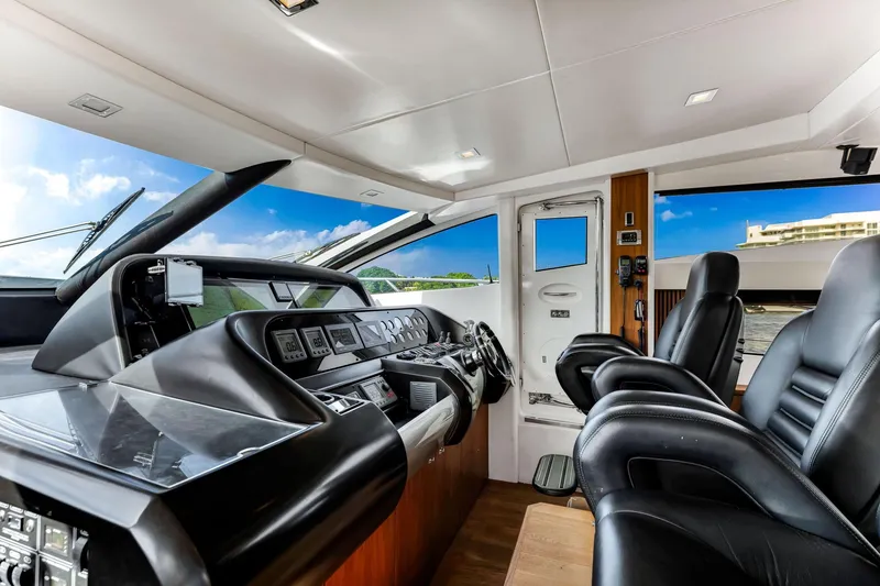 Slide: The Image of Interior cockpit of 2012 Sunseeker 74 Sport Yacht with modern controls and leather seating. - 12