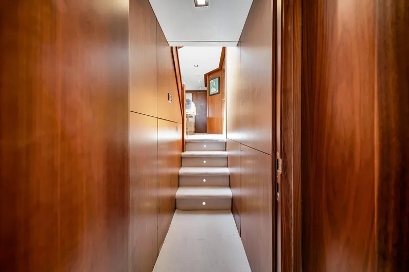 Slide: The Image of Interior hallway of 2012 Sunseeker 74 Sport Yacht with wooden paneling and carpeted stairs. - 27