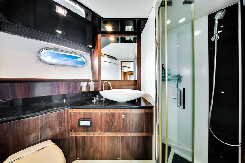 Slide: The Image of Luxurious bathroom in 2012 Sunseeker 74 Sport Yacht with modern fixtures and elegant wood accents. - 28