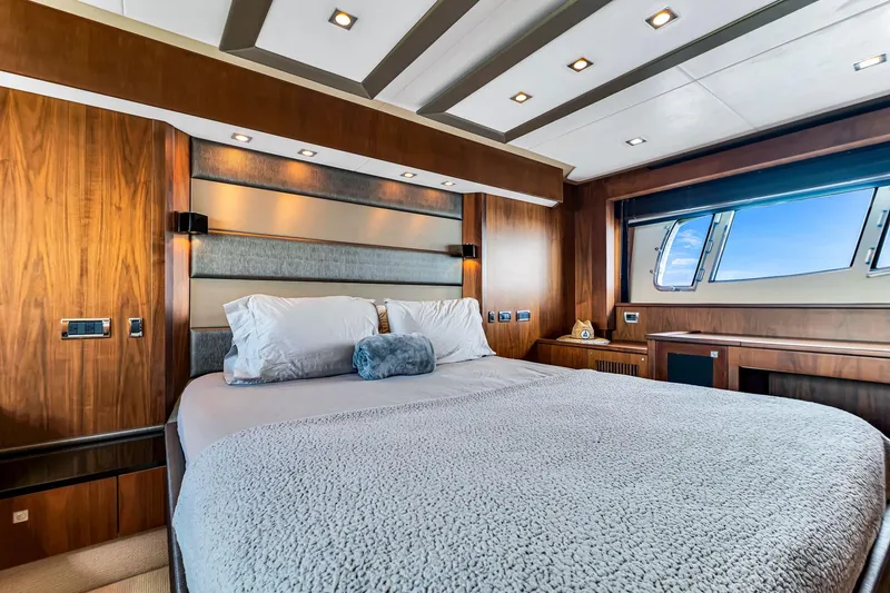 Slide: The Image of Luxurious bedroom interior of 2012 Sunseeker 74 Sport Yacht with elegant wood finishes and large window. - 31